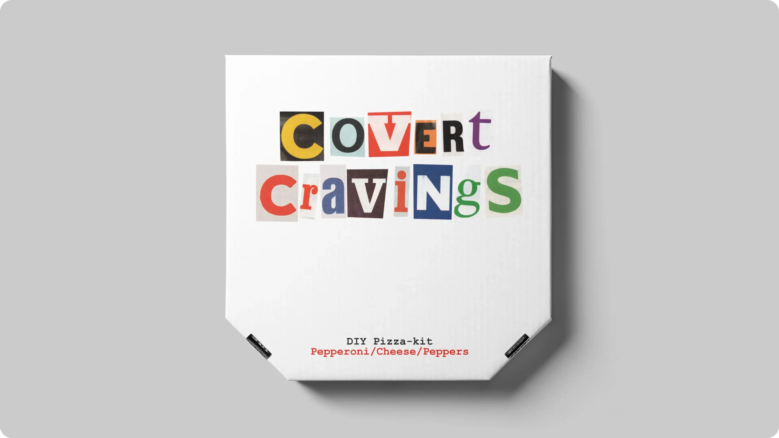 Image showing a pizzabox seen from above with branding on it.The branding is cut out letters saying "Covert Cravings".