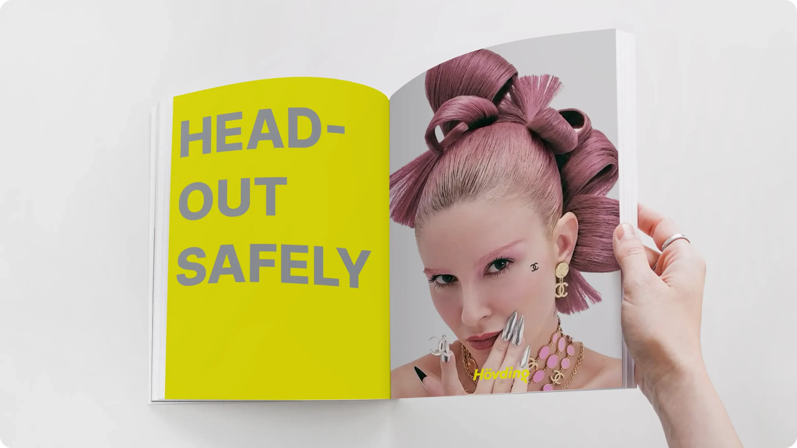 Image showing a open magazine with a text on the left saying "Head out safely". O the right is an image of a girl.