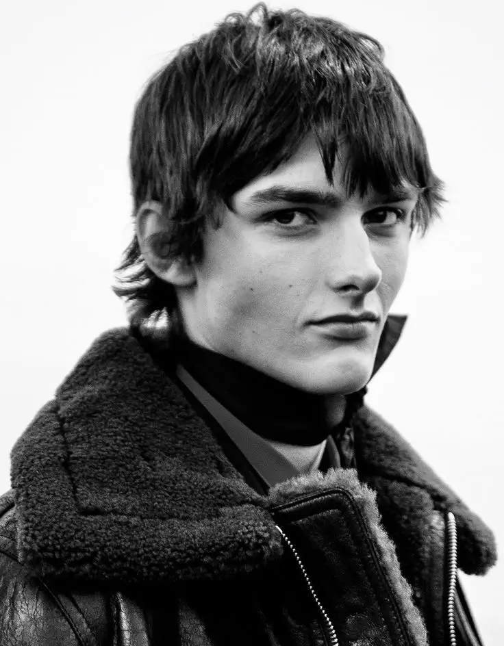 Image in black and white of a guy seen slightly from the side.
